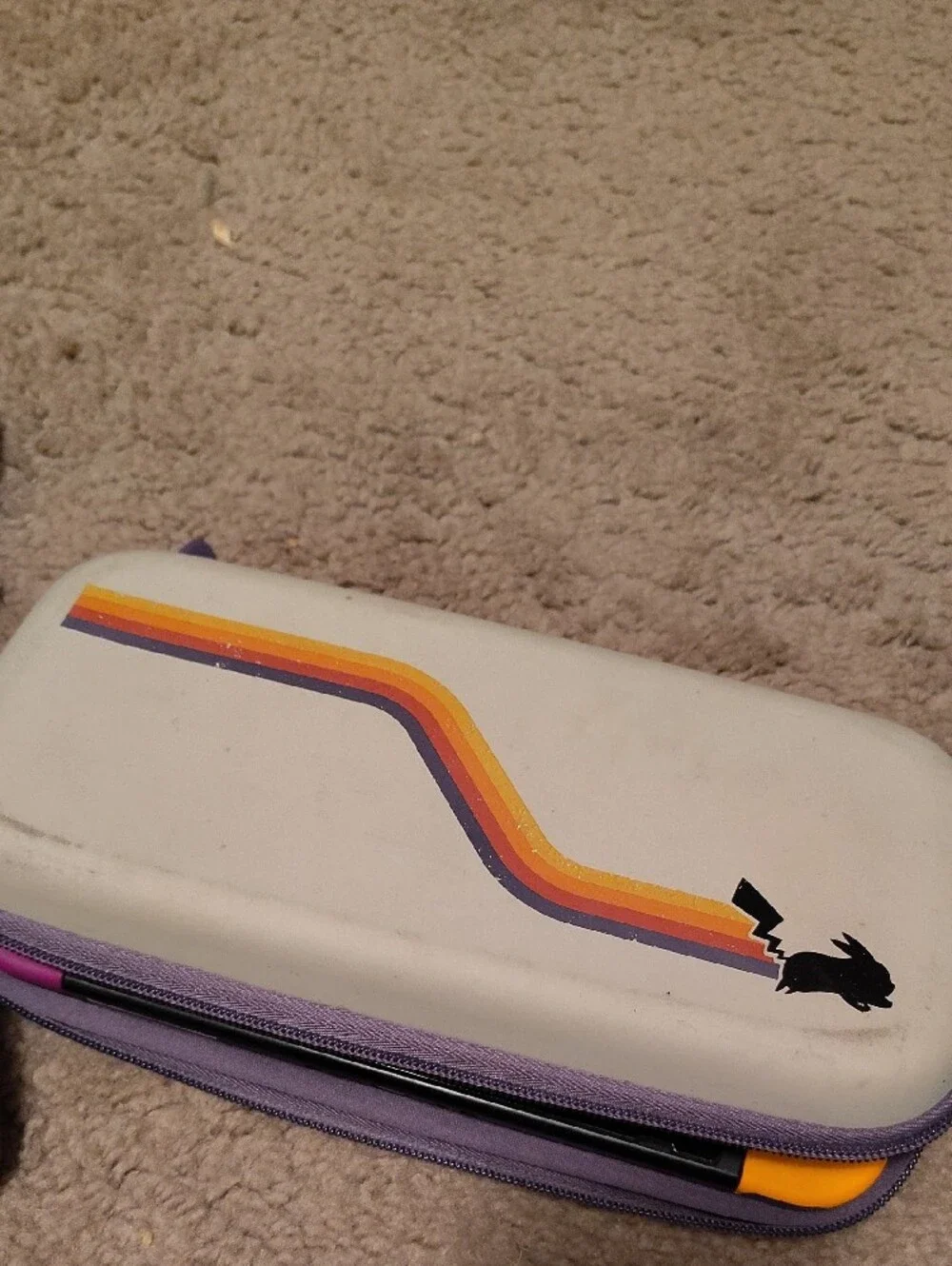 Nintendo handheld with Purple Carry Case and Yellow/Purple Joy‑Con